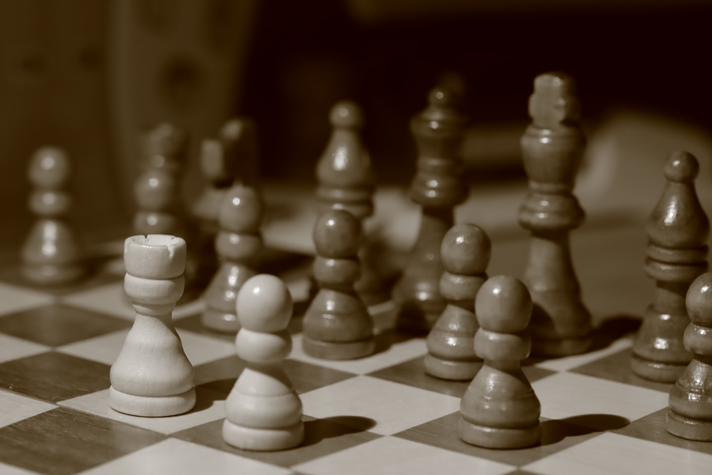 Chess pieces on a board, photographed in sepia